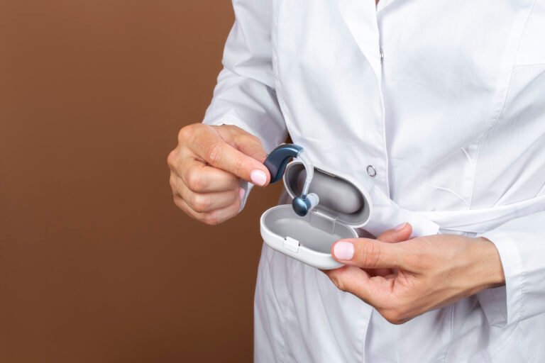 side view doctor holding hearing aids