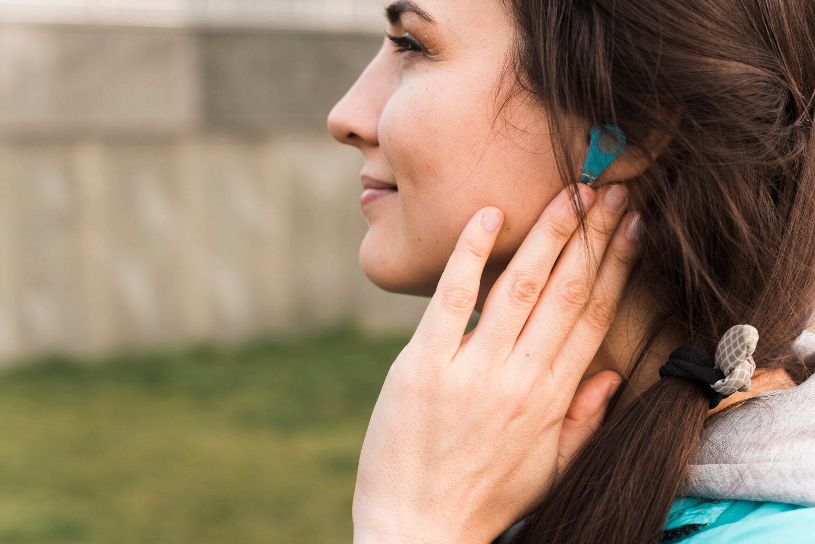 side view woman sportswear listening music
